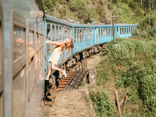 istock Tourist in Sri Lanka riding train, hanging outside 1293461062