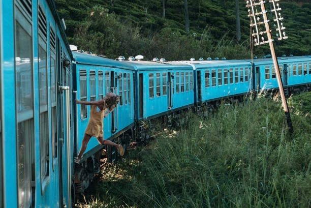 istock Tourist in Sri Lanka riding train, hanging outside 1293461188