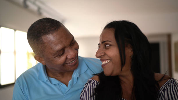 istock Happy couple looking at each other at home 1293462241