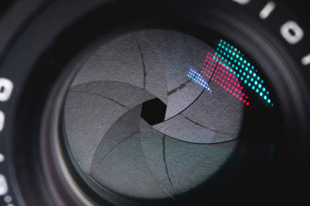 istock Close-up of a camera mirror lens front lens with aperture and highlights from a light source 1293462463