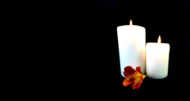 istock Candle on a black background, postcard, Flat Lai on death and funeral 1293462465