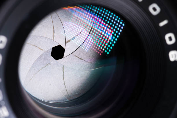 istock Close-up of a camera mirror lens front lens with aperture and highlights from a light source 1293462476