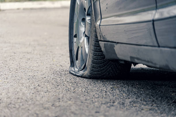 istock flat car tire close up, punctured wheel 1293462653