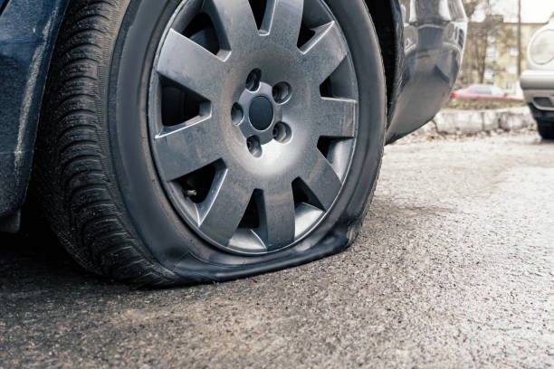 istock flat car tire close up, punctured wheel 1293462674