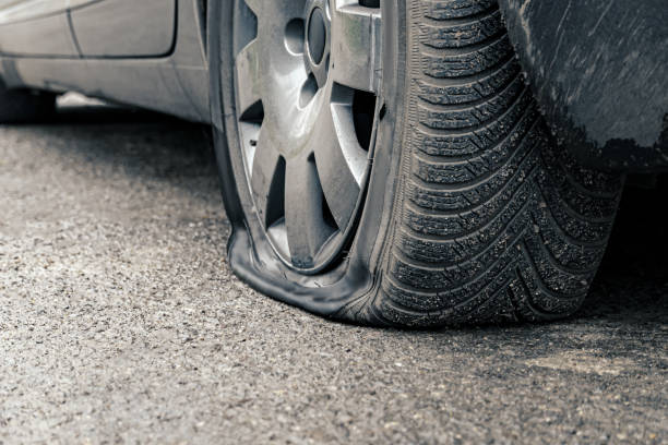 istock flat car tire close up, punctured wheel 1293462685