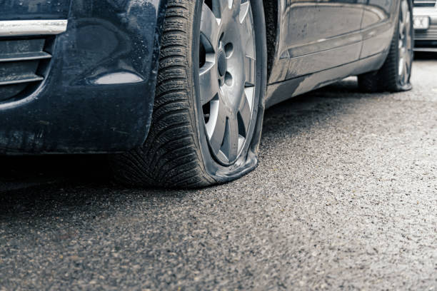 istock flat car tire close up, punctured wheel 1293462695