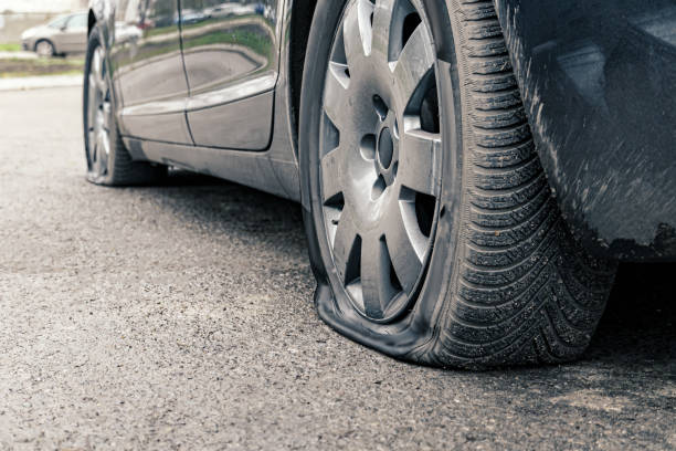 istock flat car tire close up, punctured wheel 1293462729