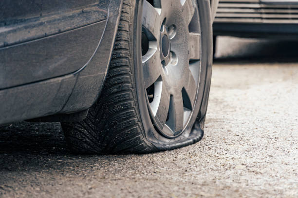 istock flat car tire close up, punctured wheel 1293462764