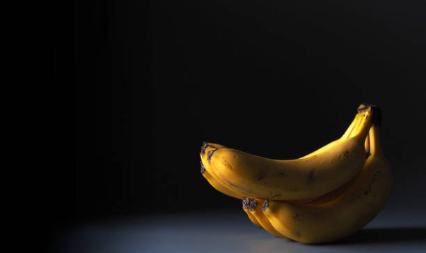 istock bunch of ripe bananas on a black background 1293463576