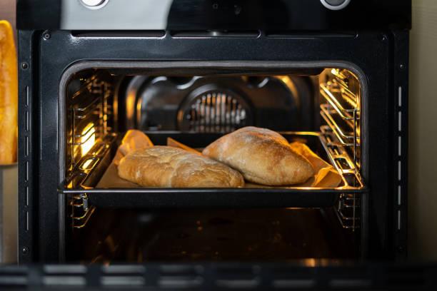 istock Modern and open oven with baked loaf inside 1293466803