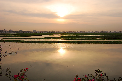 Boeung Kak lake at sunset in Phnom Penh, Cambodia. Until around 2010, was the largest urban lake in Phnom Penh before being destroyed and filled with sand.
