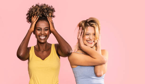 Two beautiful multiethnic women smiling and having fun together.