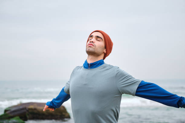 istock 20-24 years old men training at coastline on cold temperature 1293469910