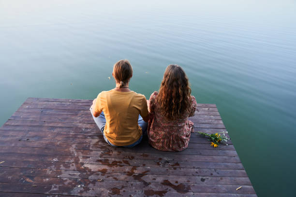 istock Couple sitting at the pier 1293470212