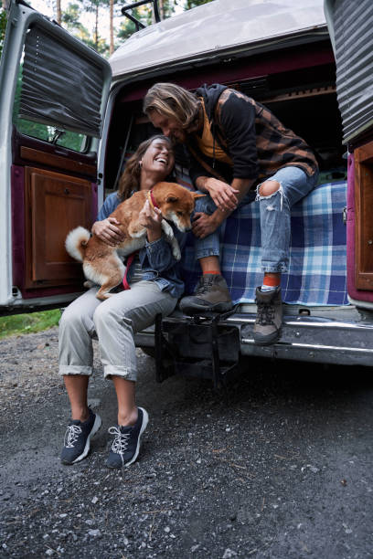 istock Couple sitting at the car trunk 1293470268