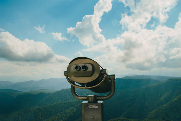 istock Binoculars with coins overlooking the Blue Mountains, Landscape with beautiful cloudy sky and mountains .. 1293471404