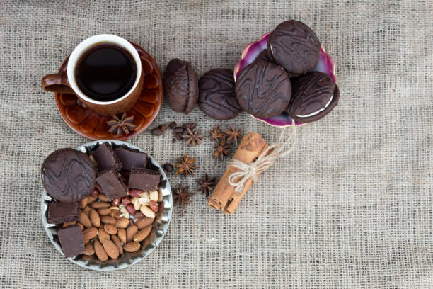istock There is a cup of coffee,  chocolate and biscuits, cinnamon sticks, coffee beans, almonds, peanuts and star anise. on the table 1293472125
