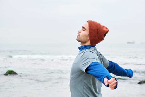 istock 20-24 years old men training at coastline on cold temperature 1293472327