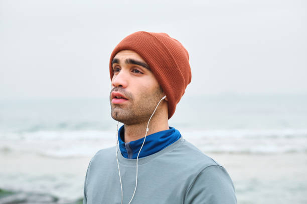 istock 20-24 years old men training at coastline on cold temperature 1293472490