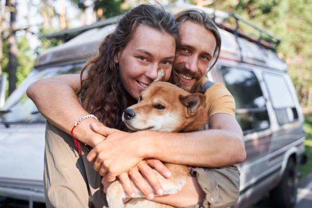 istock Couple lovingly cuddling a dog 1293472840
