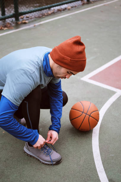istock 20-24 years old men training basketball on court 1293473875