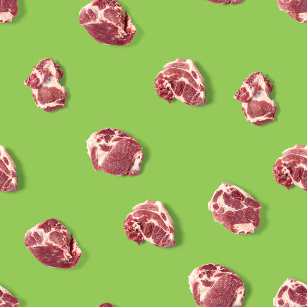 istock Seamless Pattern with raw pork meat slices on green background, food pattern 1293473913