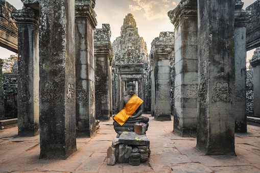 Young couple traveling in Cambodia visiting the temples of Angkor wat complex. People travel discovery Asia concept. Adventure and exploration concept in Siem Reap, Southeast Asia.