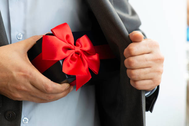 istock Businessman giving Gift Box 1293478887