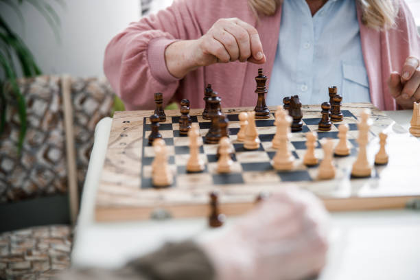 istock Retired couple playing chess on wooden table 1293481196
