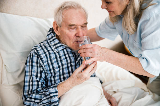 istock Woman caring sick elderly man 1293481333