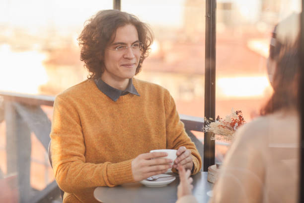 istock Man meeting with friend in cafe 1293483088