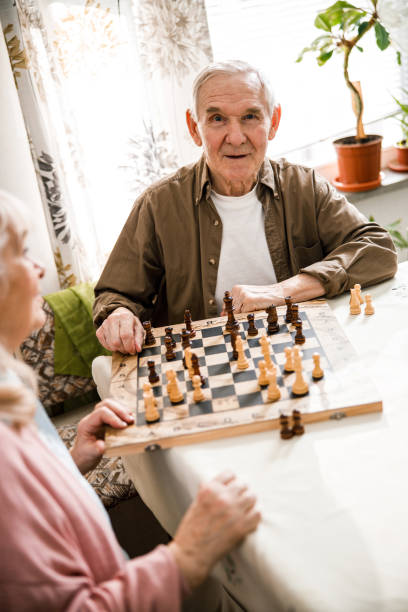 istock Husband and wife are playing chess 1293483452