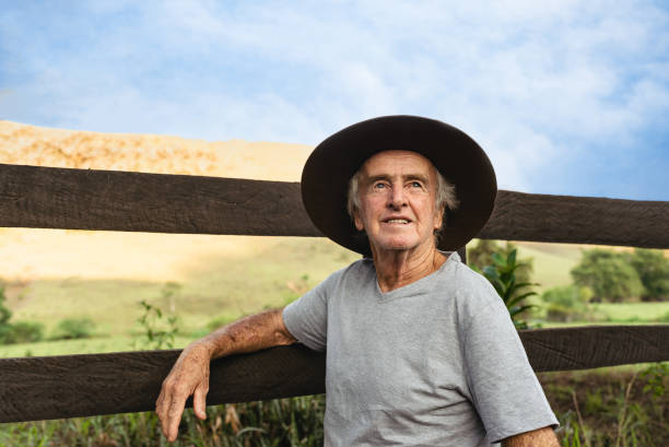 Hopeful farmer on the fence Hopeful farmer on the fence town of hope stock pictures, royalty-free photos & images