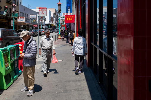 San Francisco, California - July 30, 2014: Street scene with people on a sidewalk at the Grant Avenue, in the hearth of Chinatown, in the city of San Francisco.