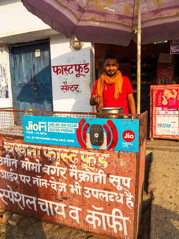 Indian man cooking right on the street, Pawalgarh village, Uttarakhand, India