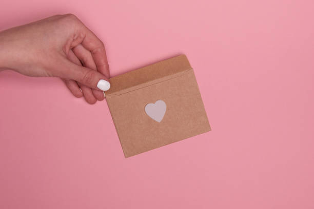 istock Valentine day composition. Confetti, envelope postcard with white heart on pastel background 1293488950