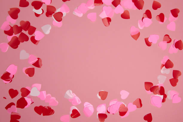 istock Valentine day composition. Confetti hearts red and pink on pastel background 1293489010
