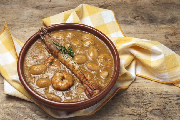 Homemade White Bean Stew with Prawns Traditional Homemade White Bean Stew with Prawns. Typical Spanish food. on wooden background fabes stock pictures, royalty-free photos & images