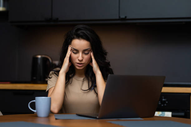 istock Upset woman working from home office. Unhappy freelancer using laptop and the Internet workplace in cozy kitchen. Concept of female business and career, housekeeping, stress. Lifestyle moment. 1293489141
