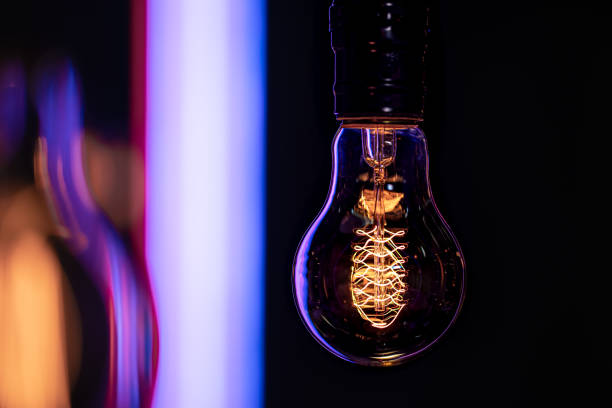istock Close up of a burning lamp on a blurred dark background. 1293493854