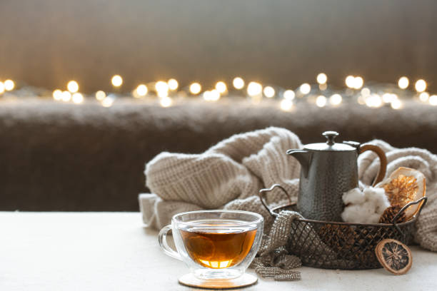 istock Cozy composition with glass cup of tea on blurred background with boke. 1293493934