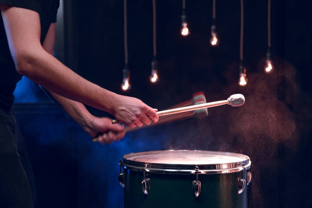istock The drummer plays with mallets on floor tom in dark room. 1293494943