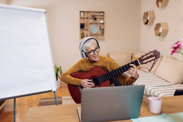 istock Mature music professor having an online guitar class 1293495093