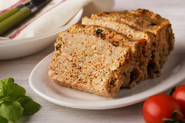 istock Meatloaf - sliced meat loaf on white plate 1293497352