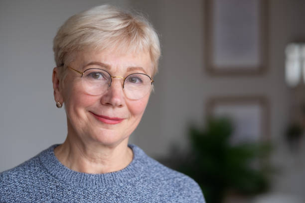 istock Senior woman with glasses, looking at camera, smiling. 1293500826