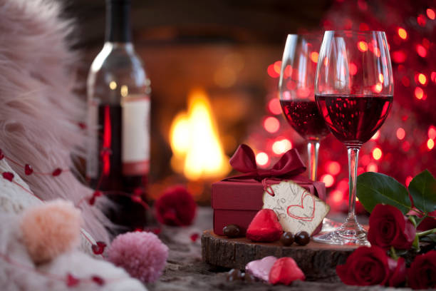 istock Valentine's Day Gift and Red Wine in front of the Fireplace 1293501277
