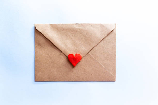 istock love letter in a craft envelope with clay red heart on light blue background. 1293502903