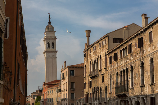 A seagull flies past the leaning bell tower of the Campanile of San Giorgio dei Greci, in Venice, Italy. This is one of 10 leaning towers in the whole of Italy.