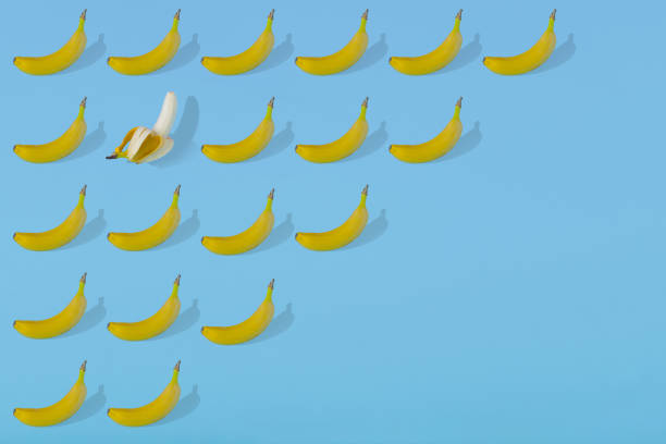 istock Trendy Summer pattern made with fresh banana fruit on bright light blue background 1293504704