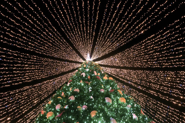 istock Christmas tree covered with garlands ribbons 1293505075